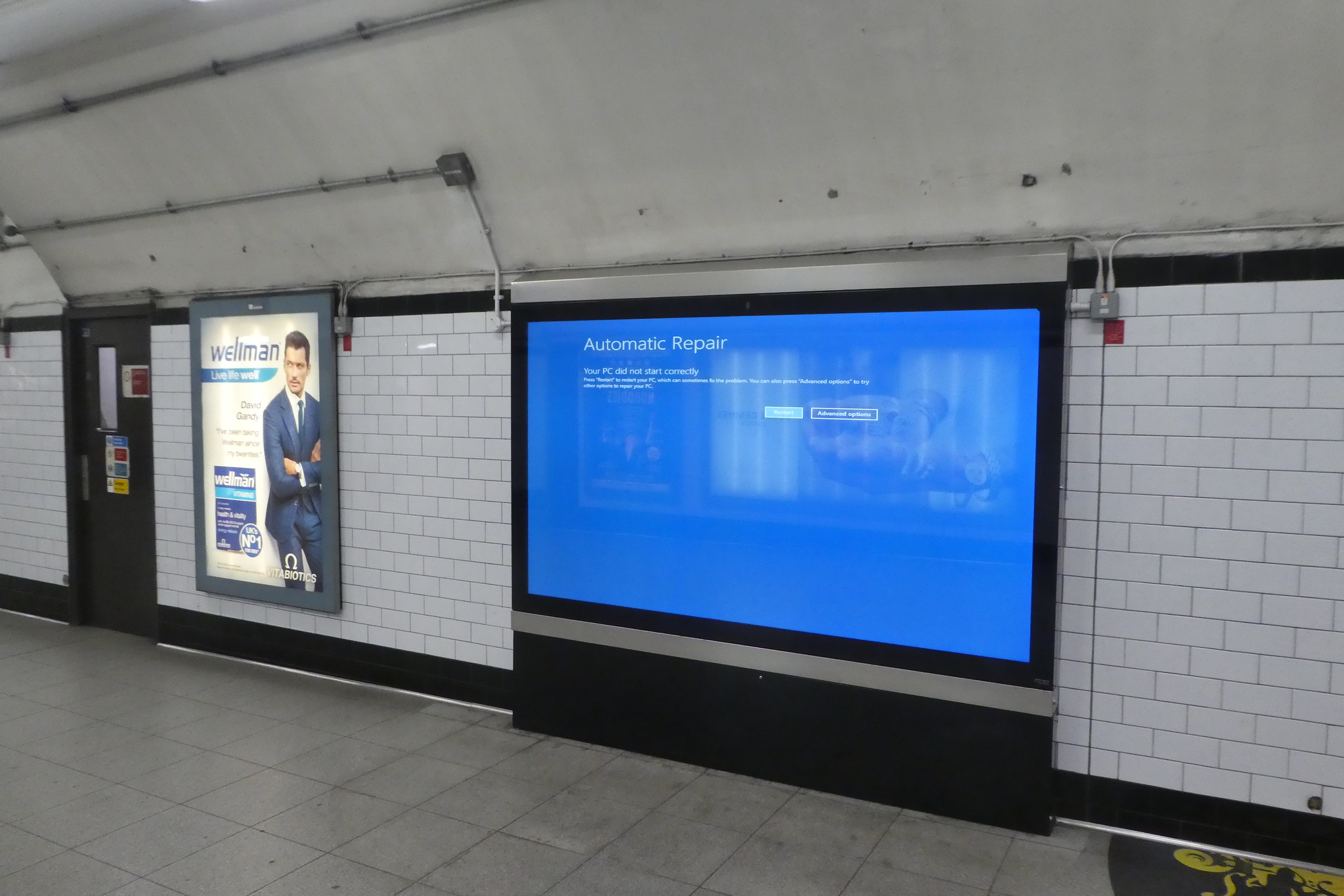 A Blue Screen of Death on an advertising screen on the London Underground.